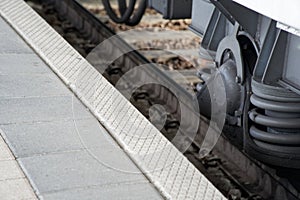 Train wheel close-up with large spring