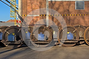 Train wheel sets in front of an industrial building