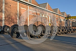Train wheel sets in front of an industrial building