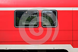 Train windows of a red train from outside