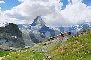 Train from Zermatt to Gornergrat moves on Matterhorn mountain background