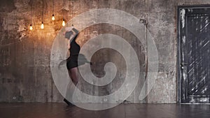 Trained dancer girl is swirling in a dramatic dance in a dark gothic hall