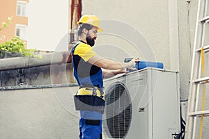 Trained engineer mending air conditioner