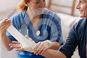 Trained experienced doctor applying medical bandage