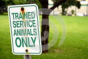 Trained service animals only sign at park in summer photo