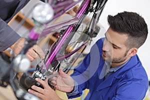 Trainee mechanic working on bicycle