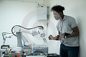 Trainee Robotics engineer learning with Programming and Manipulating Robot Hand, Industrial Robotics Design, High Tech Facility,