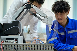 Trainee Robotics engineer learning with Programming and Manipulating Robot Hand, Industrial Robotics Design, High Tech Facility,