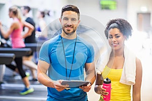 Trainer and client smiling at camera