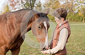 Trainer Feeding Horse