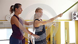 Trainer giving woman training with exercise band