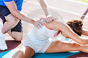 Trainer helping during strech out