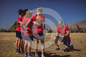 Trainer instructing kids in the boot camp