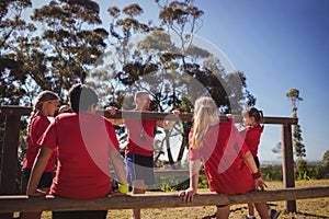 Trainer instructing kids during obstacle course training