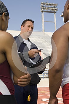 Trainer Instructing Male Athletes