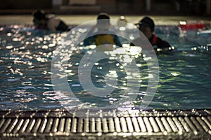 trainer practive child to swim. Blurred abstract