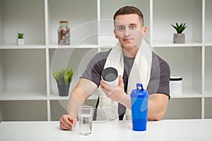 Trainer prepares a protein shake in the shaker after training