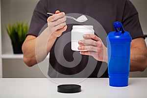 Trainer prepares a protein shake in the shaker after training.