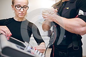 Trainer setting up ems device