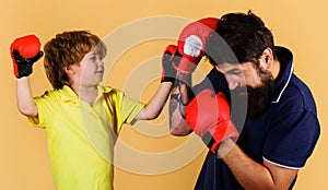 Trainer teaching kid how to hit punches. Boxing child training. Childhood activity. Fitness day.