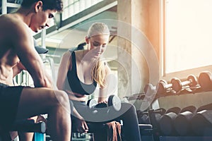 Trainer training exercise with man and woman at the gym for healthy care and body slim.  Fitness instructor exercising with his cl