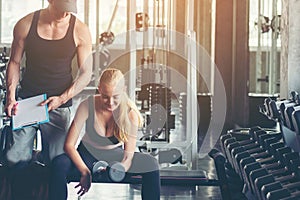 Trainer training exercise with man and woman at the gym for healthy care and body slim.  Fitness instructor exercising with his cl