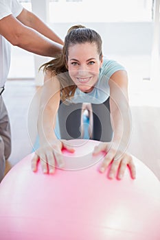 Trainer with woman on exercise ball