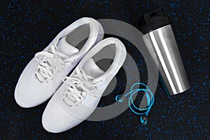 Trainers and bottle on a home gym floor