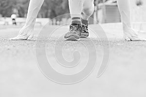 Trainers of runner starting his marathon on flat treadmill