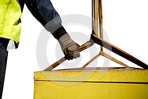 Trainesd rigger construction worker wearing heavy duty glove holding safety tag line on two tones yellow lifting sling photo