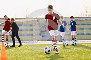 Training action of boys soccer teams, aged 10-12, playing at football practice pitch