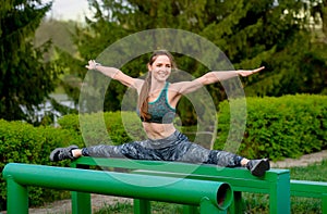 Training body to perfection. Beautiful  girl stretches a twine on a sports ground