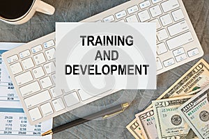 Training and Development is written in a document on the office desk, diagram and keyboard