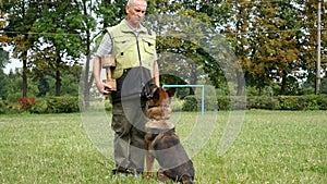 Training dog. Man teaching commands his German Shepherd