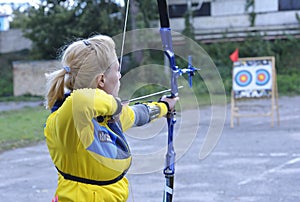 Female archer aiming at a mark on an archery shooting range