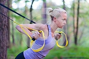 Training with fitness straps outdoors.