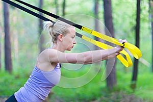 Training with fitness straps outdoors.