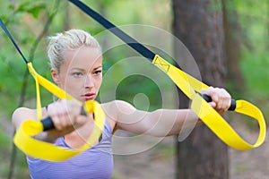 Training with fitness straps outdoors.