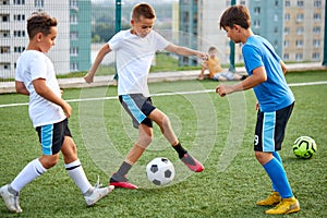 Training and football match between youth soccer teams in stadium