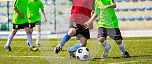 Training and football match between youth teams. Young boys playing football