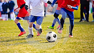 Training and football match between youth teams. Young boys playing football match