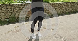 Training with jump rope, intense strength exercise outdoor. Men doing difficult cardio workout with jump rope and mask