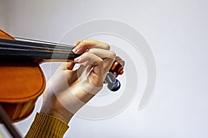 training the left hand on the strings on the student's violin. Musical education