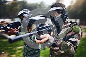 Training, paintball gun and men in camouflage with safety gear at military game for target practice. Teamwork, shooting