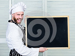 Training professional chefs. Man holding empty blackboard. Master cook giving cooking class. Chief cook teaching master