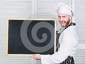 Training professional chefs. Man holding empty blackboard. Master cook giving cooking class. Chief cook teaching master