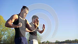 Training a Wing Chun between master and follower on sky background. 4k