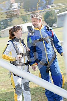 Trainne and teacher skydivers getting in plane