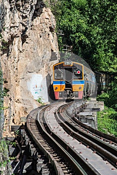 Trains running on death railways track crossing kwai river in kanchanaburi thailand