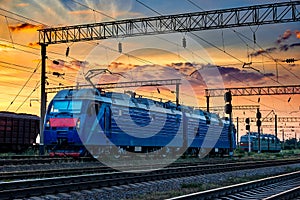 Trains and wagons, railroad infrastructure, beautiful sunset and colorful sky, transportation and industrial concept